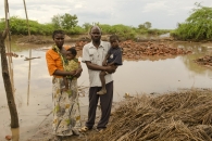 Tamara Damiano (left)g, with Caroline, and Matthews Damiano with Precious, in front of their destroyed house.